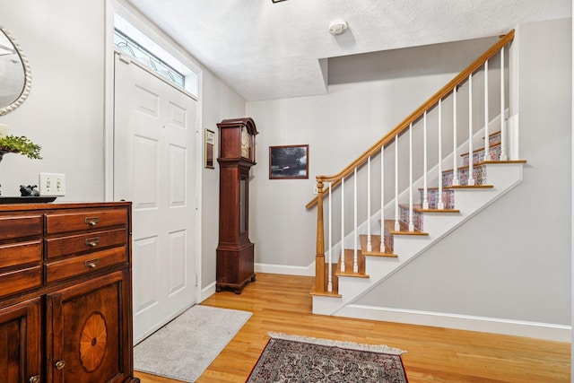 27 Olde Common Dr, Atkinson, NH 03811 - foyer featuring light wood-type flooring and stairs