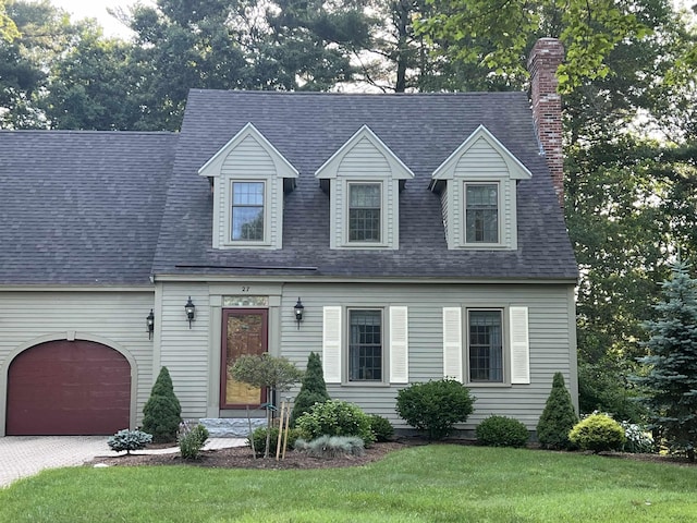 27 Olde Common Dr, Atkinson, NH 03811 - cape cod home with a chimney, a front yard, driveway, and roof with shingles