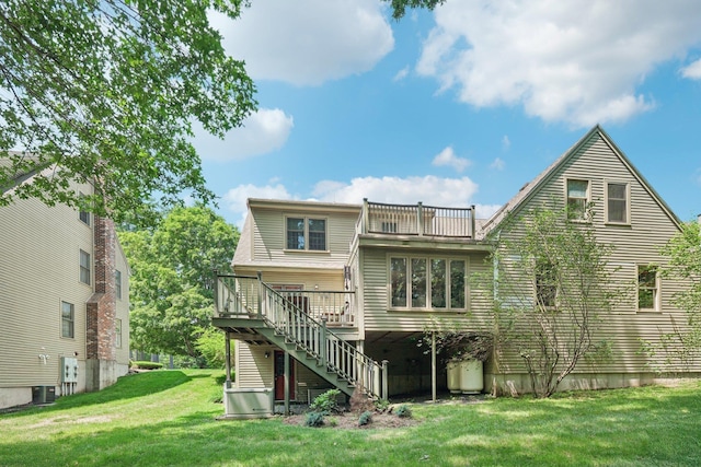 27 Olde Common Dr, Atkinson, NH 03811 - back of house with stairs, a lawn, a wooden deck, and a balcony