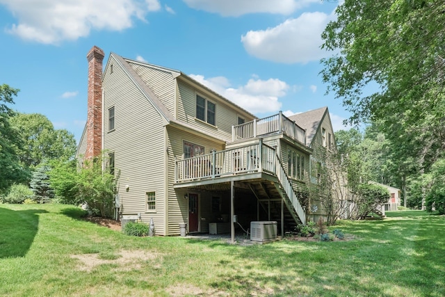 27 Olde Common Dr, Atkinson, NH 03811 - rear view of property featuring a chimney, a lawn, a deck, and a balcony