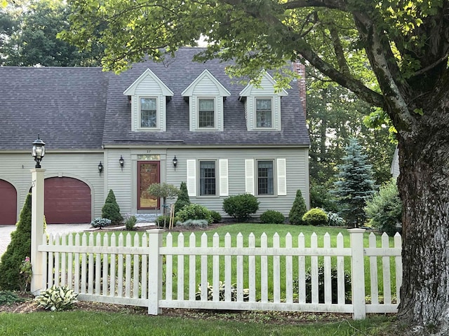 27 Olde Common Dr, Atkinson, NH 03811 - cape cod house featuring an attached garage, driveway, and a shingled roof