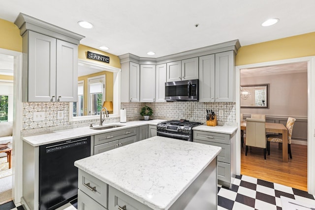 27 Olde Common Dr, Atkinson, NH 03811 - kitchen with gray cabinets, appliances with stainless steel finishes, tile patterned floors, a center island, and tasteful backsplash