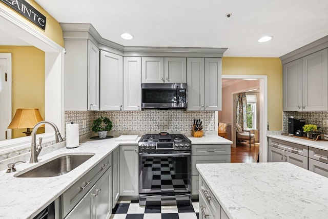 27 Olde Common Dr, Atkinson, NH 03811 - kitchen with stainless steel appliances, gray cabinets, light stone countertops, tasteful backsplash, and dark floors
