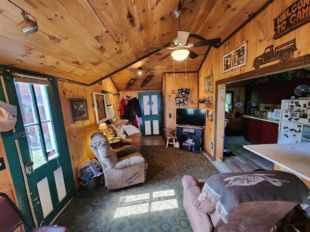 106 Nanas Ln, Concord, VT 05824 - living room with lofted ceiling, wood ceiling, wood walls, a ceiling fan, and wood finished floors
