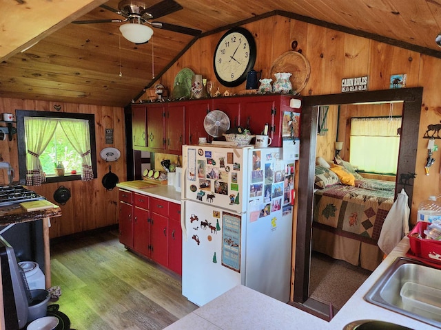 106 Nanas Ln, Concord, VT 05824 - kitchen featuring vaulted ceiling, freestanding refrigerator, wood walls, wooden ceiling, and light wood-style flooring