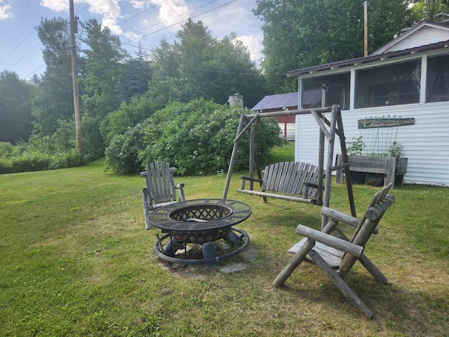106 Nanas Ln, Concord, VT 05824 - view of grassy yard with an outdoor fire pit and a sunroom