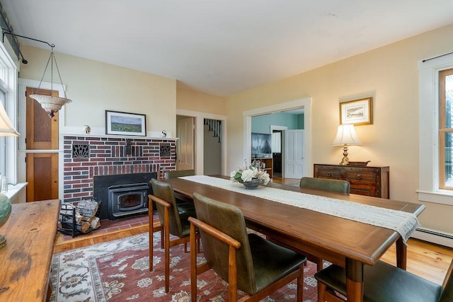 49 Mason Rd, Brookline, NH 03033 - dining space featuring wood finished floors, a wood stove, and plenty of natural light