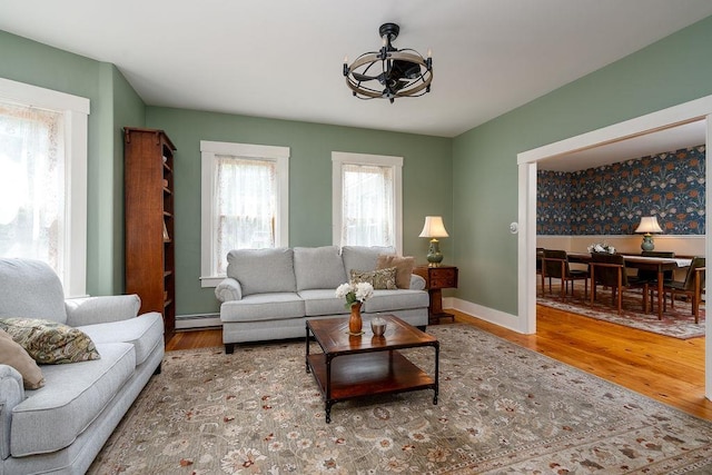 49 Mason Rd, Brookline, NH 03033 - living area featuring baseboard heating, wood finished floors, and a chandelier