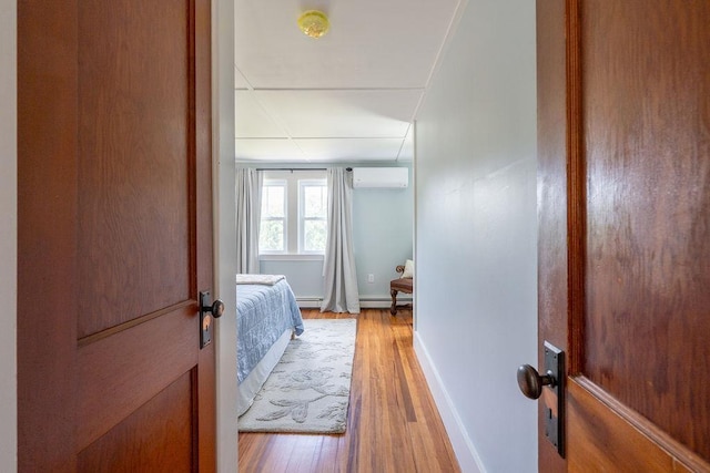 49 Mason Rd, Brookline, NH 03033 - hallway with a wall unit AC, light wood-type flooring, and baseboard heating