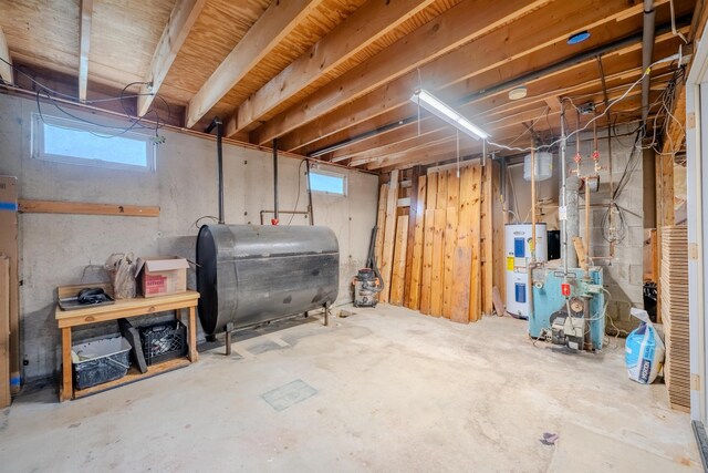 15 Prospect St, Farmington, NH 03835 - below grade area featuring oil tank, electric water heater, and a heating unit