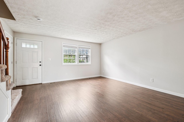 272 Winding Pond Rd Unit 272, Londonderry, NH 03053 - entrance foyer featuring stairs, a textured ceiling, and dark wood finished floors