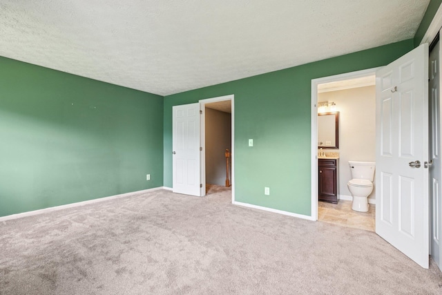272 Winding Pond Rd Unit 272, Londonderry, NH 03053 - unfurnished bedroom featuring light colored carpet, a textured ceiling, and ensuite bathroom