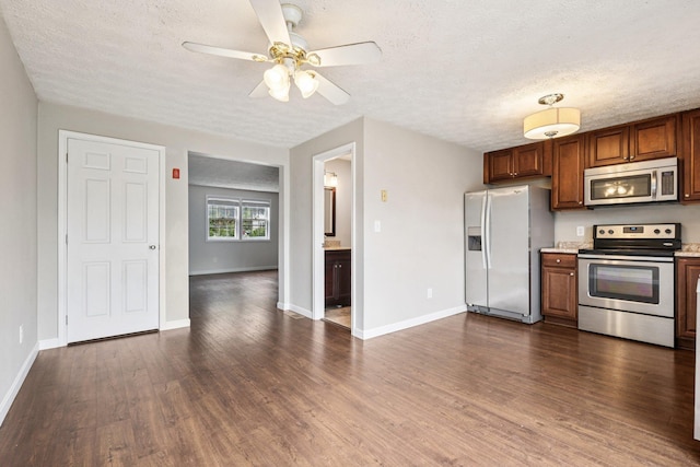 272 Winding Pond Rd Unit 272, Londonderry, NH 03053 - kitchen featuring appliances with stainless steel finishes, dark wood finished floors, light countertops, a textured ceiling, and ceiling fan