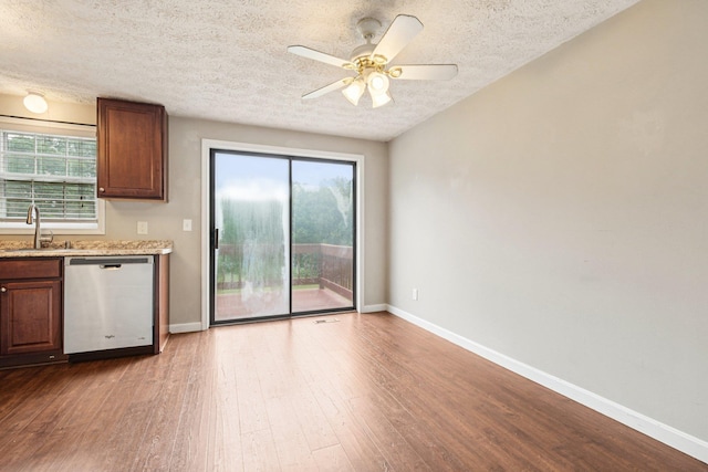 272 Winding Pond Rd Unit 272, Londonderry, NH 03053 - kitchen featuring stainless steel dishwasher, a textured ceiling, wood finished floors, plenty of natural light, and a ceiling fan