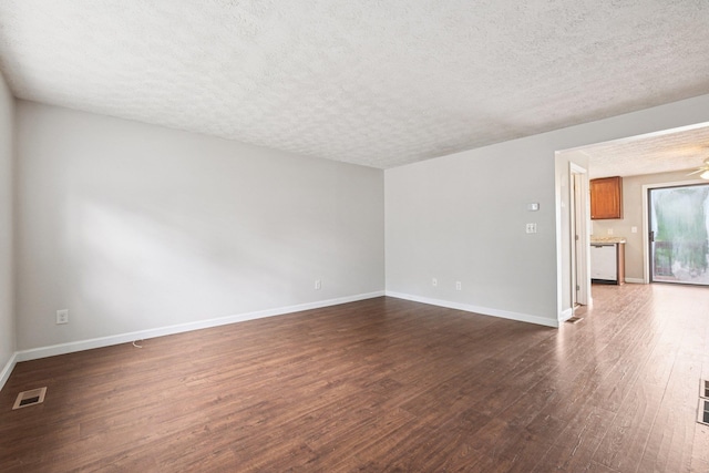 272 Winding Pond Rd Unit 272, Londonderry, NH 03053 - empty room featuring a textured ceiling and dark wood finished floors