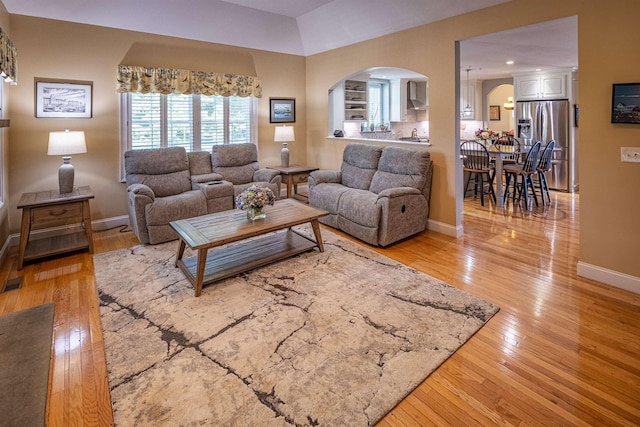 1 Sonia Dr, Dover, NH 03820 - living area with arched walkways and light wood finished floors