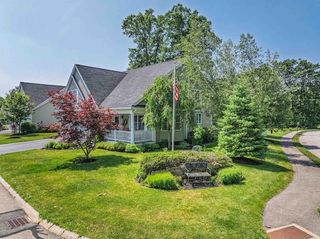 1 Sonia Dr, Dover, NH 03820 - view of front facade featuring a front yard, a shingled roof, a porch, and driveway