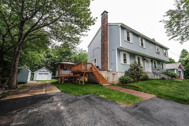 2L Homestead Dr Unit L, Derry, NH 03038 - view of front of home featuring a chimney, an outbuilding, stairs, a garage, and a front lawn