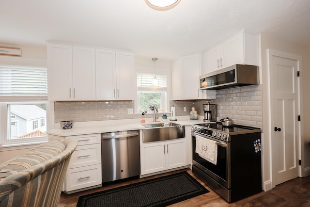 2L Homestead Dr Unit L, Derry, NH 03038 - kitchen with stainless steel appliances, decorative backsplash, white cabinets, and light countertops