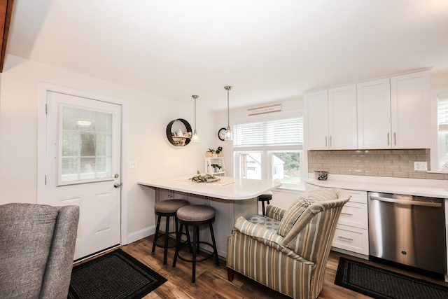 2L Homestead Dr Unit L, Derry, NH 03038 - kitchen with dishwasher, a kitchen breakfast bar, white cabinets, light countertops, and dark wood-style floors