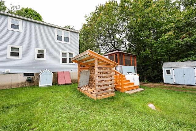 2L Homestead Dr Unit L, Derry, NH 03038 - rear view of property featuring a storage shed, a sunroom, and a yard