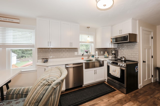 2L Homestead Dr Unit L, Derry, NH 03038 - kitchen with appliances with stainless steel finishes, white cabinets, backsplash, dark wood-style floors, and light countertops
