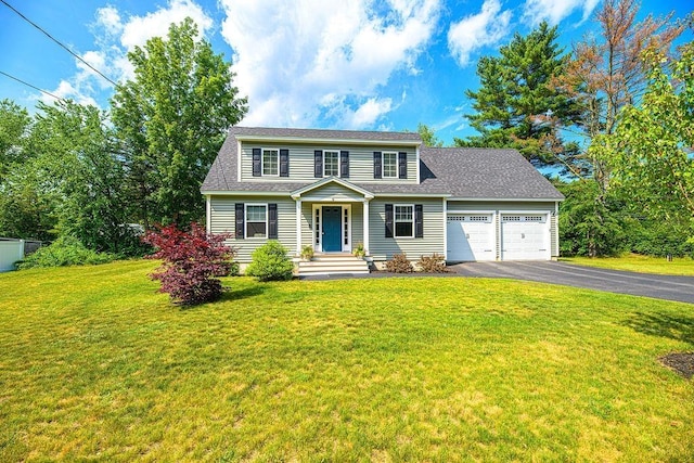 9 Marshall Rd, Kingston, NH 03848 - traditional home with asphalt driveway, a garage, a front lawn, and a shingled roof