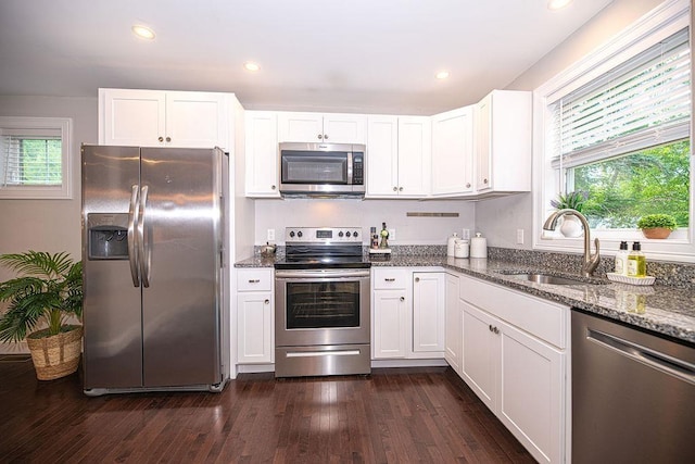 9 Marshall Rd, Kingston, NH 03848 - kitchen featuring appliances with stainless steel finishes, dark stone countertops, white cabinets, dark wood-type flooring, and recessed lighting