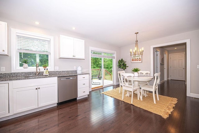 9 Marshall Rd, Kingston, NH 03848 - kitchen with stainless steel dishwasher, dark stone counters, a chandelier, white cabinets, and dark wood finished floors