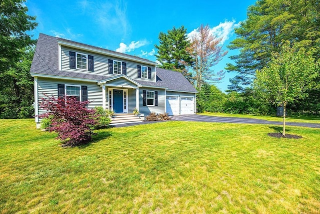 9 Marshall Rd, Kingston, NH 03848 - view of front of house with asphalt driveway, a garage, a front lawn, and a shingled roof