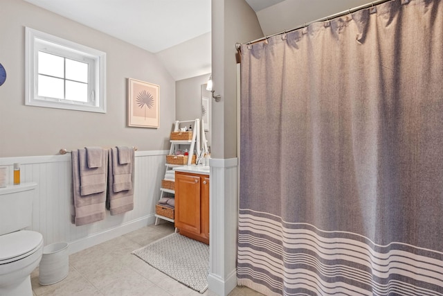47 Misty Oak Dr, Concord, NH 03301 - bathroom with a wainscoted wall, vanity, vaulted ceiling, tile patterned floors, and a shower with curtain