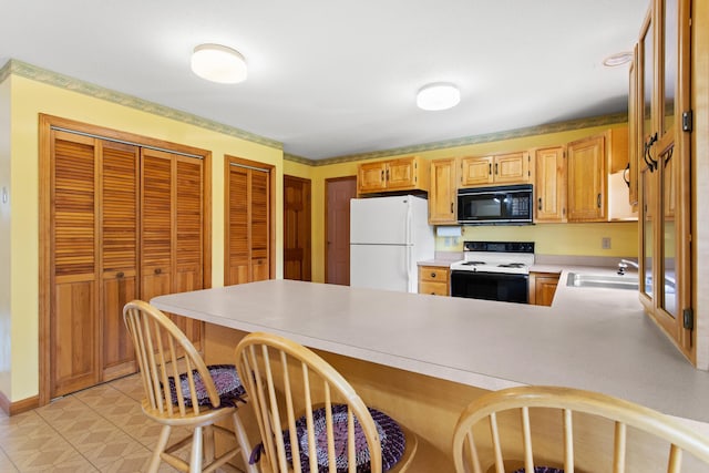 1A Rowland St, Somersworth, NH 03878 - kitchen featuring black microwave, electric stove, freestanding refrigerator, a peninsula, and light countertops