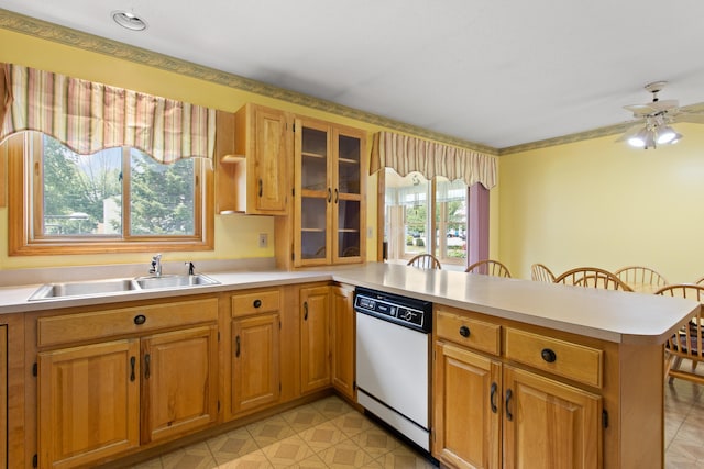 1A Rowland St, Somersworth, NH 03878 - kitchen with white dishwasher, a peninsula, light countertops, glass insert cabinets, and a kitchen breakfast bar
