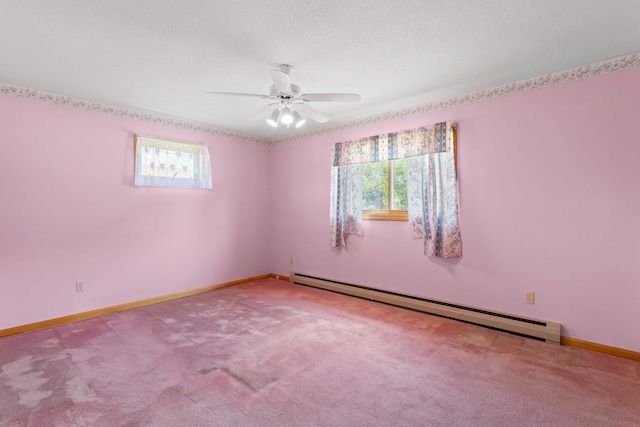1A Rowland St, Somersworth, NH 03878 - empty room featuring a baseboard radiator, healthy amount of natural light, ceiling fan, and carpet