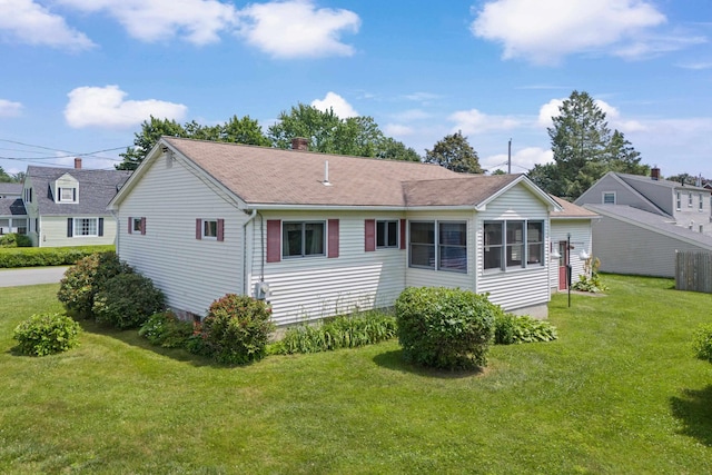 1A Rowland St, Somersworth, NH 03878 - rear view of property featuring a lawn, a chimney, and roof with shingles