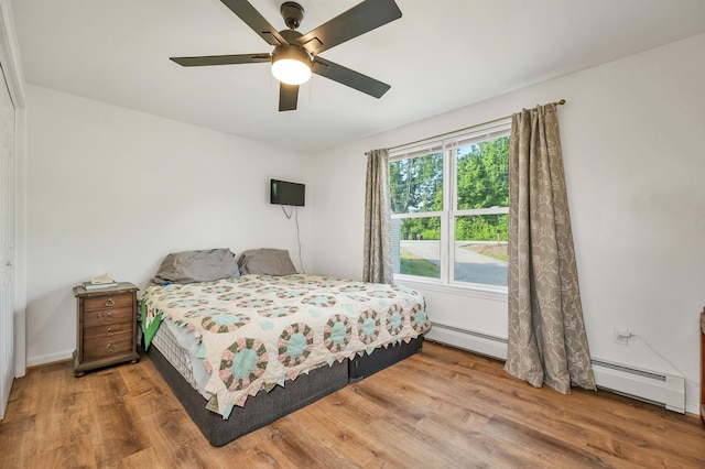 145 Bow Lake Rd, Barnstead, NH 03218 - bedroom featuring a baseboard heating unit, wood finished floors, and a ceiling fan