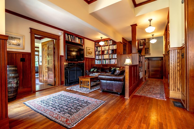 109 Reserve Pl, Concord, NH 03301 - living room featuring a fireplace, a wainscoted wall, wood finished floors, crown molding, and stairs
