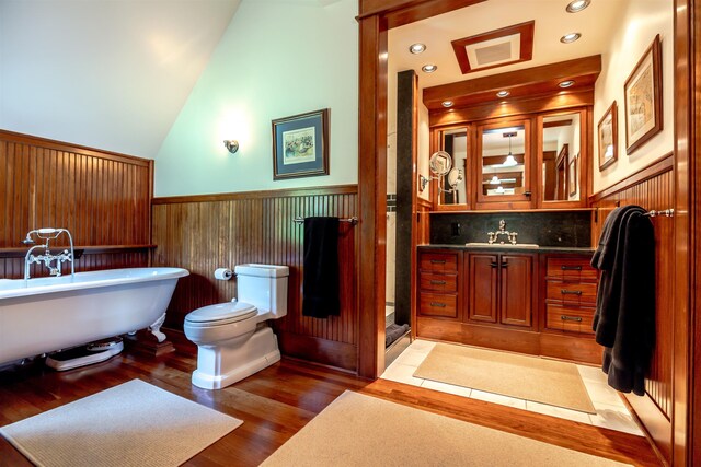 109 Reserve Pl, Concord, NH 03301 - bathroom featuring a wainscoted wall, a freestanding tub, vanity, wood finished floors, and vaulted ceiling