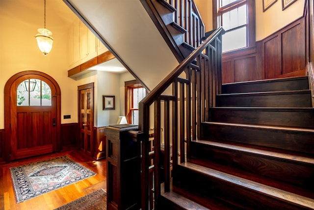 109 Reserve Pl, Concord, NH 03301 - foyer featuring stairway, wainscoting, wood finished floors, a towering ceiling, and wooden walls
