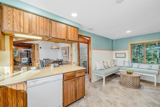 6 Cove Rd, Wakefield, NH 03830 - kitchen featuring dishwasher, a wood stove, light countertops, open floor plan, and a wainscoted wall