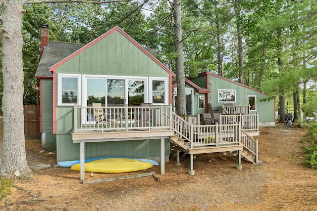 6 Cove Rd, Wakefield, NH 03830 - back of property with a wooden deck, a shingled roof, and a chimney