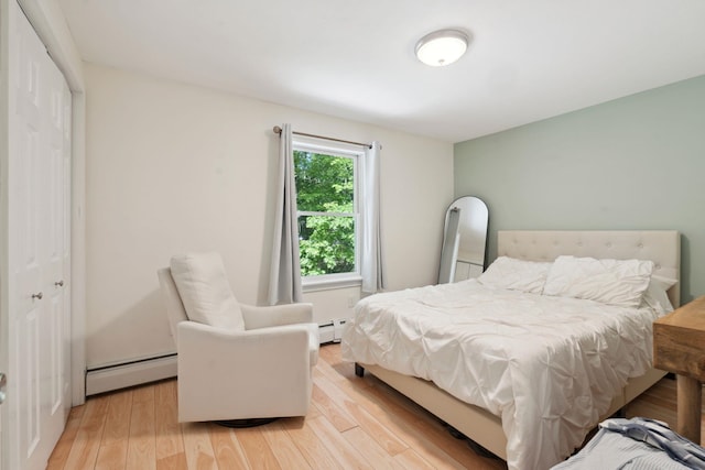 115 Blackwater Rd, Somersworth, NH 03878 - bedroom with a baseboard heating unit and light wood-style flooring