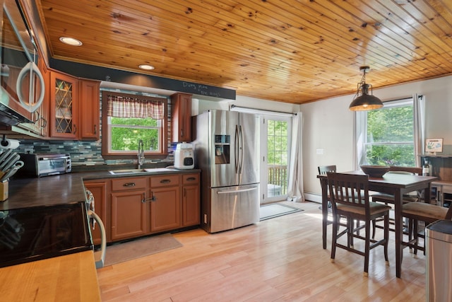 115 Blackwater Rd, Somersworth, NH 03878 - kitchen with stainless steel appliances, dark countertops, plenty of natural light, brown cabinetry, and wooden ceiling