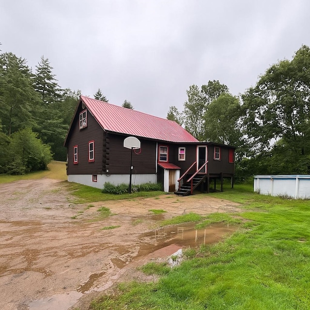 131 Gilmanton Rd, Belmont, NH 03220 - view of front of home with an outdoor pool, a metal roof, and log siding