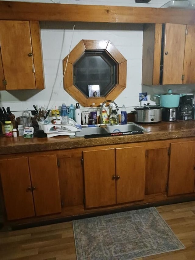131 Gilmanton Rd, Belmont, NH 03220 - kitchen featuring brown cabinets, wood finished floors, and dark countertops