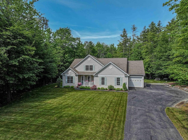 138 Page Rd, New London, NH 03257 - view of front facade with driveway, an attached garage, a porch, and a front lawn