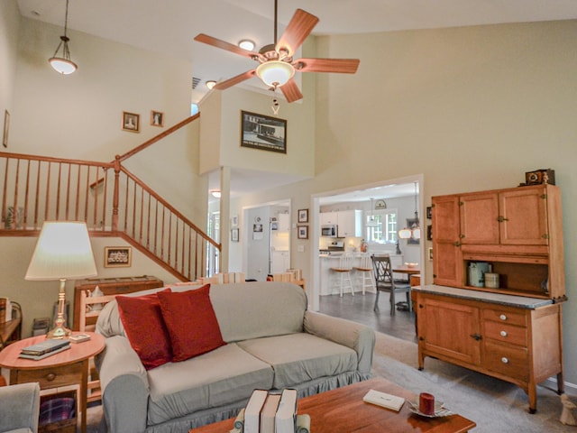 138 Page Rd, New London, NH 03257 - living room with ceiling fan, stairway, and a towering ceiling