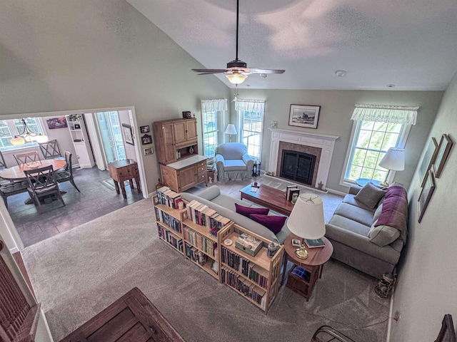 138 Page Rd, New London, NH 03257 - living area with a premium fireplace, a ceiling fan, a textured ceiling, high vaulted ceiling, and carpet flooring