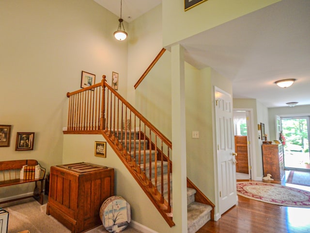 138 Page Rd, New London, NH 03257 - staircase featuring baseboards and wood finished floors