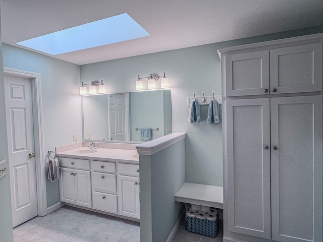 138 Page Rd, New London, NH 03257 - full bathroom with a skylight, double vanity, and tile patterned flooring